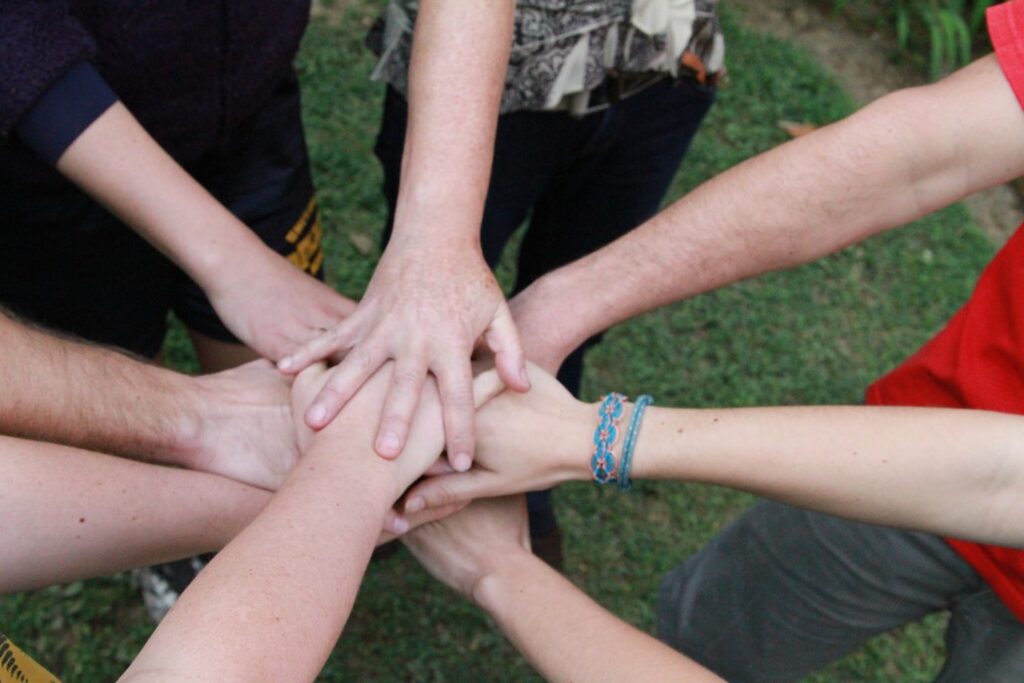 Team stacking hands during team building